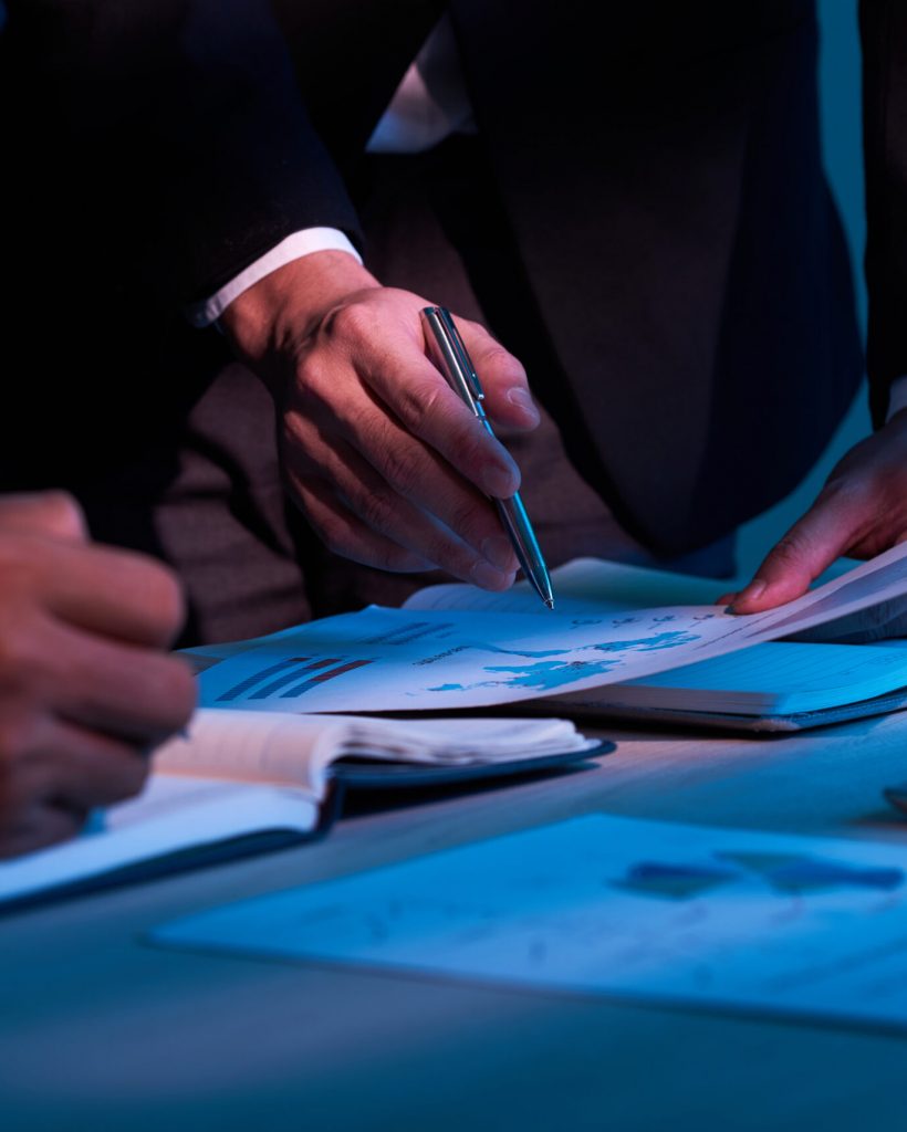 Close-up image of business partners working with financial documents